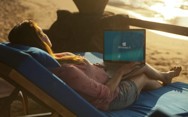 Woman Using Gray Laptop on Beach